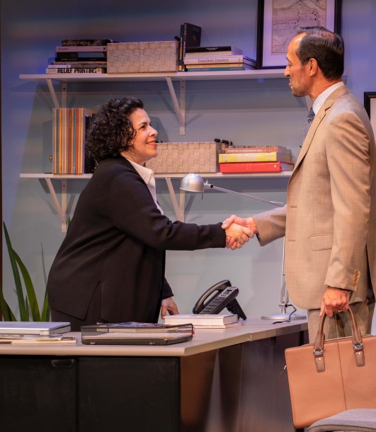 Carmen Pelaez (left) as Camila, greets art dealer Roman (Philip Hernandez) in FAKE, Miami New Drama's production of Pelaez's play. Photo by Stian Roenning.